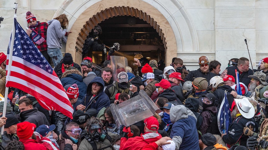 Police use pepper spray against pro-Trump rioters outside the Capitol Building.