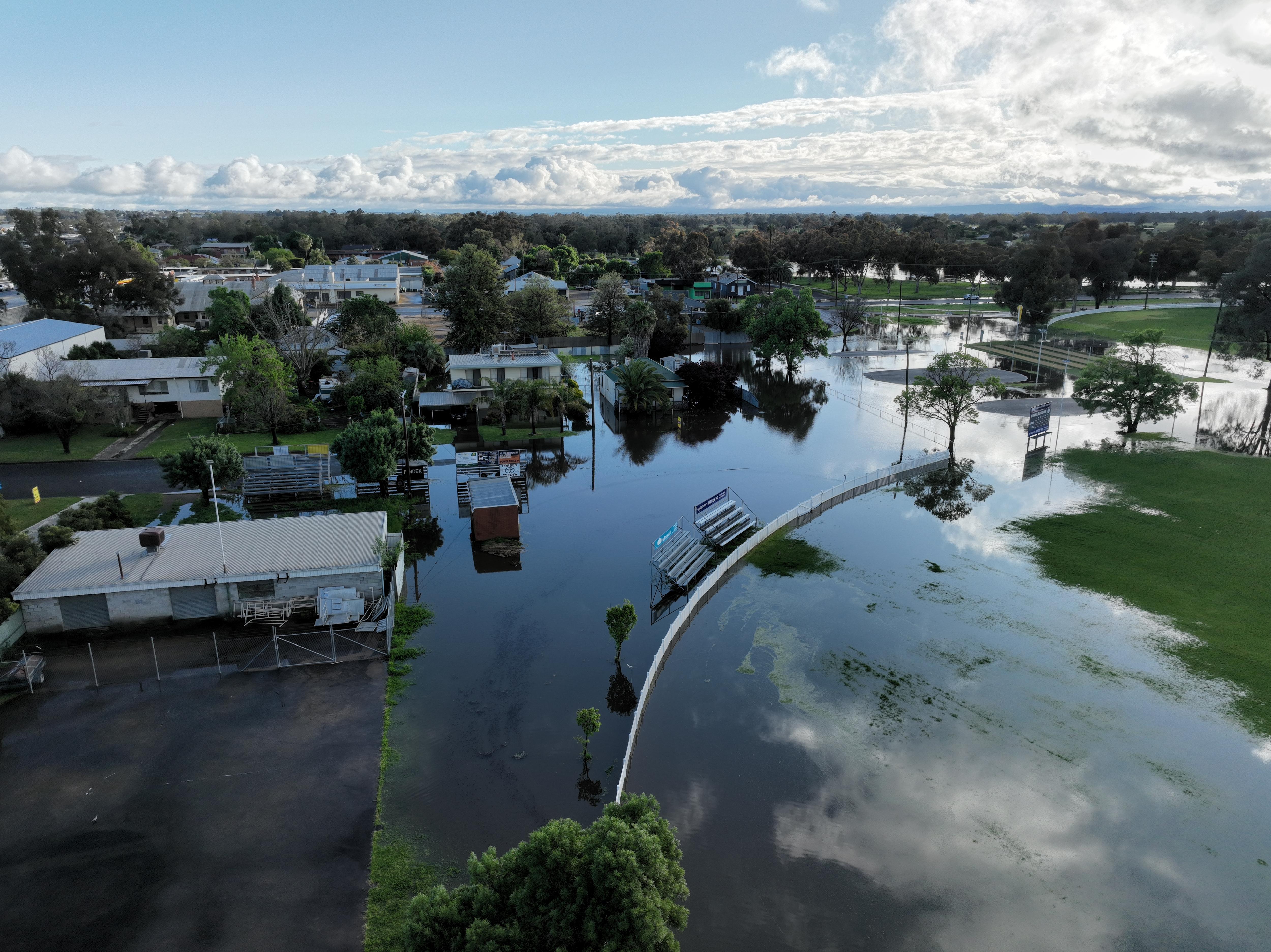 aerial view of a floodwaters encroaching homes