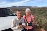 Birdwatchers Jill and John Healy leaning against their car in the Flinders Ranges.