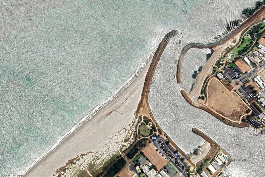 An aerial photo of where an inlet meets the ocean