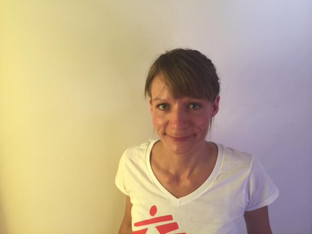 A photo of a woman wearing a white shirt, with the MSF logo on it.