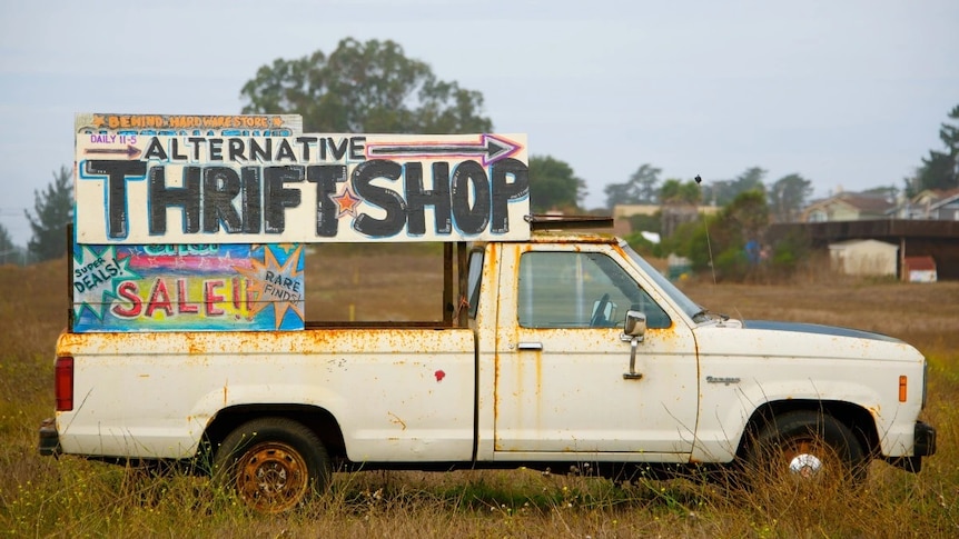 Van with sign for a thrift shop