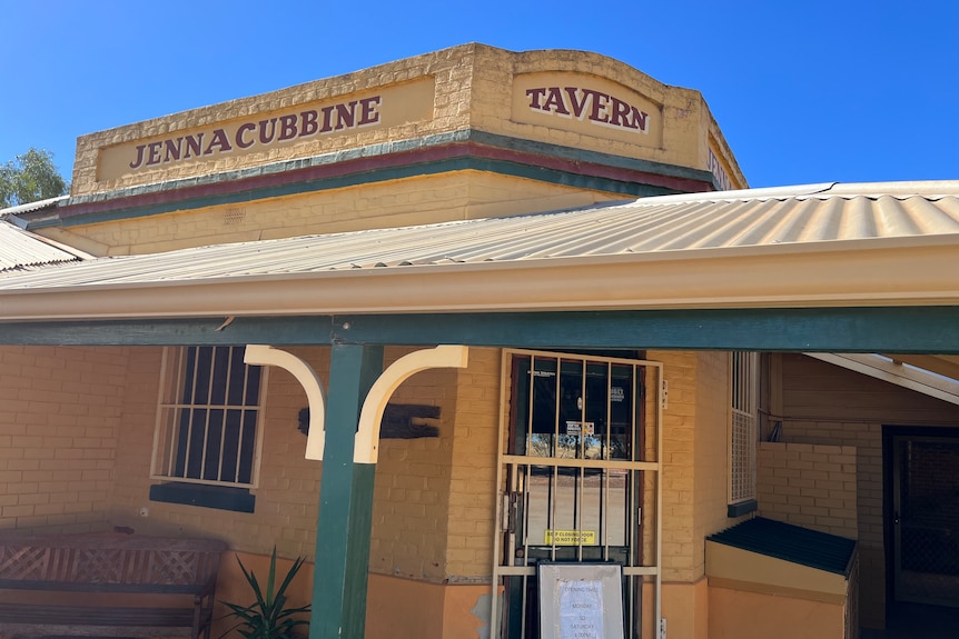 Cream building with verandah and name Jennacubbine Tavern painted on