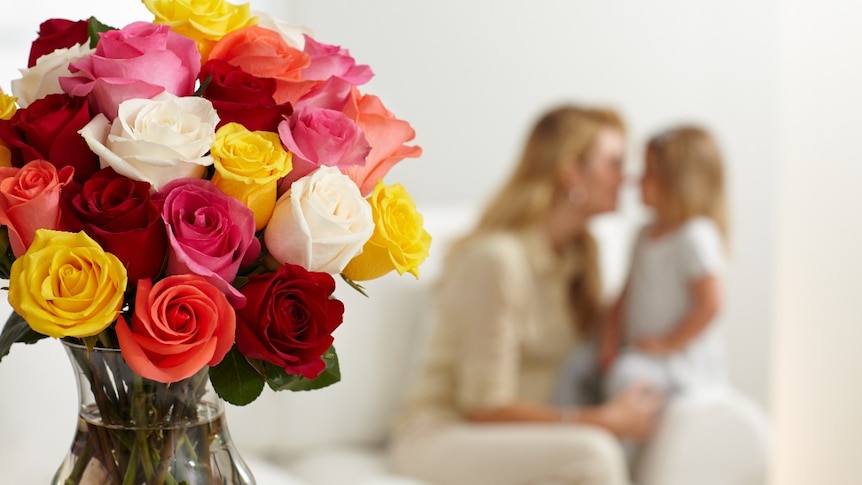 Roses with mother and child in background