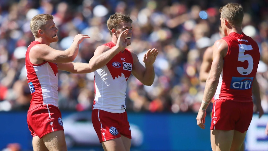 Luke Parker of the Sydney Swans receives congratulations after kicking a goal against Adelaide.