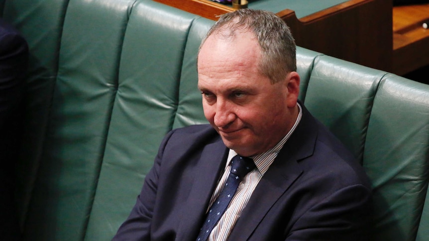 Barnaby Joyce sits with his arms crossed, rolling his eyes during Question Time