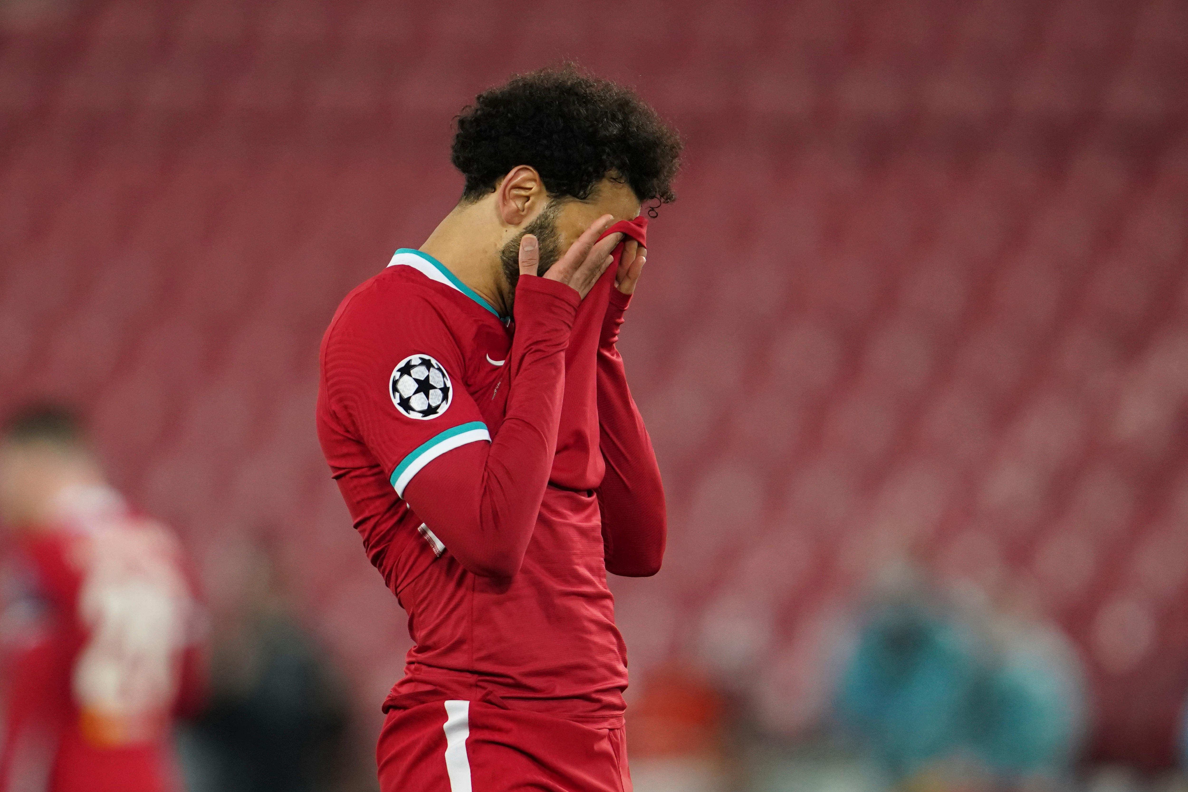 Mo Salah holds his jersey over his face in disappointment