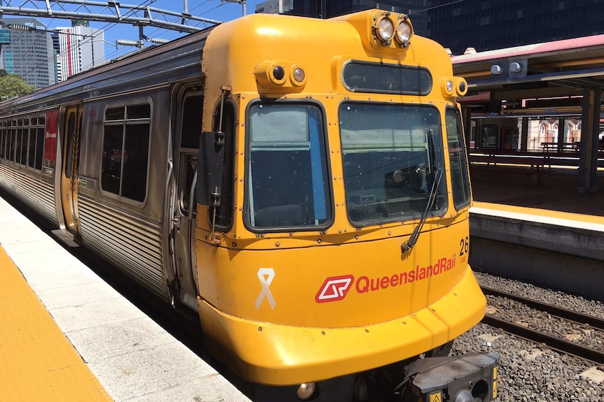 Queensland Rail train pulls up to a platform