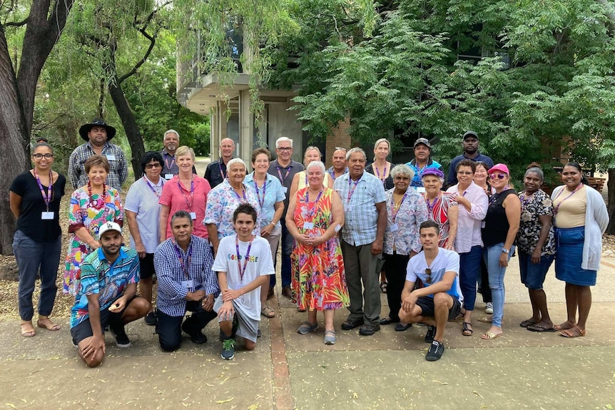 A group of almost 30 people stand together at the University of Queensland's Gatton campus.