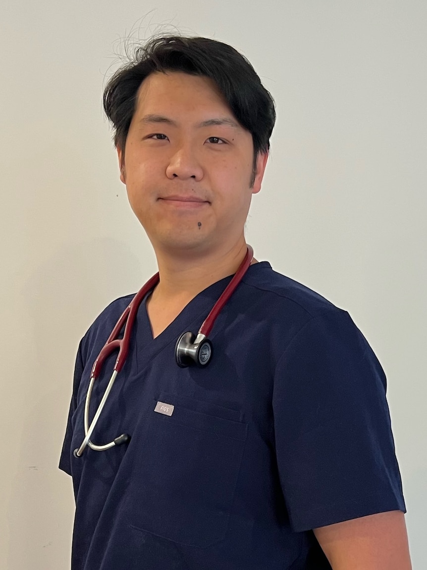 Justin Teng wearing scrubs and a stethoscope.