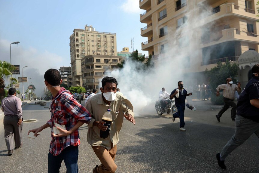 Muslim Brotherhood supporters run from tear gas fired by Egyptian police as they try to disperse protest camps in Cairo.