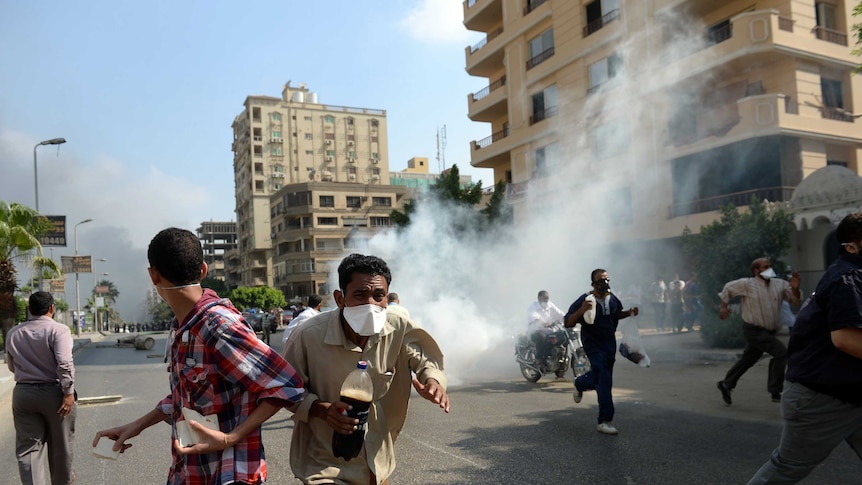 Muslim Brotherhood supporters run from tear gas fired by Egyptian police as they try to disperse protest camps in Cairo.