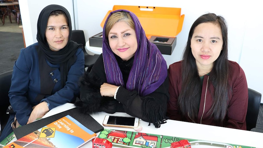 (LtoR) Husnia Muhammad Ali, Behnaz Sadeghi and Hla Myo New smile as they sit at a table.