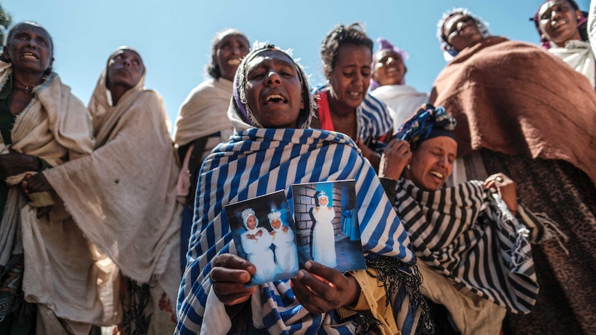Women mourn the victims of a massacre allegedly perpetrated by Eritrean soldiers