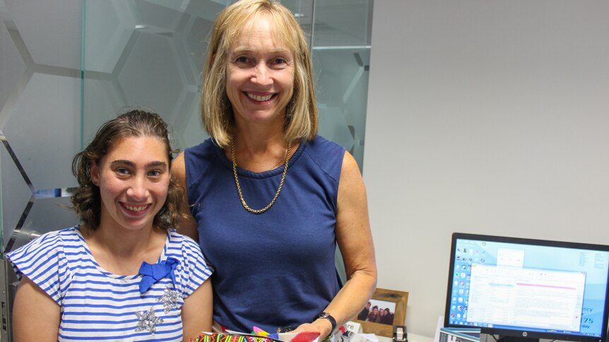 Dr Clare Nourse receives a gift from the social enterprise store, hand delivered by Freya.