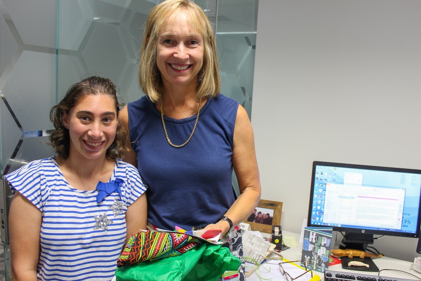 Dr Clare Nourse receives a gift from the social enterprise store, hand delivered by Freya.