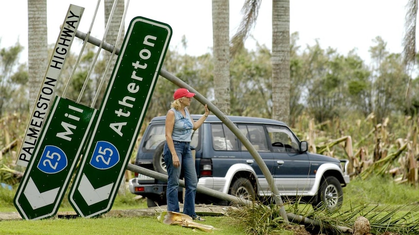 Anne Fitzpatrick surveys roadside damage in the wake of Cyclone Larry