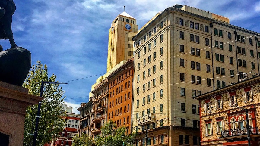 A city street lined with buildings on a clear day.