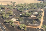 An aerial picture of burnt and collapsed buildings.
