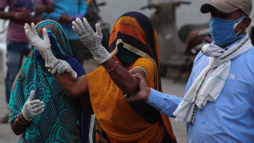 A relative of a patient who died of COVID-19, mourns outside a government COVID-19 hospital in Ahmedabad.