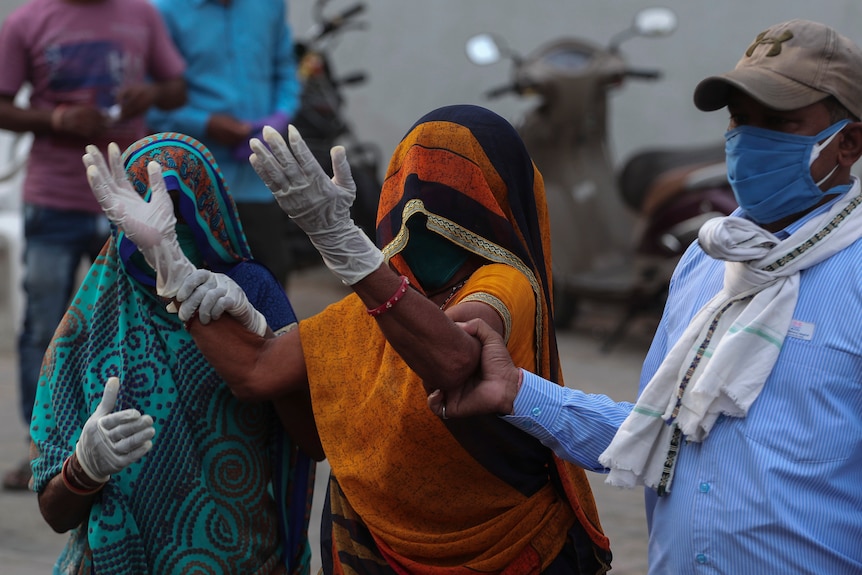 A relative of a patient who died of COVID-19, mourns outside a government COVID-19 hospital in Ahmedabad.