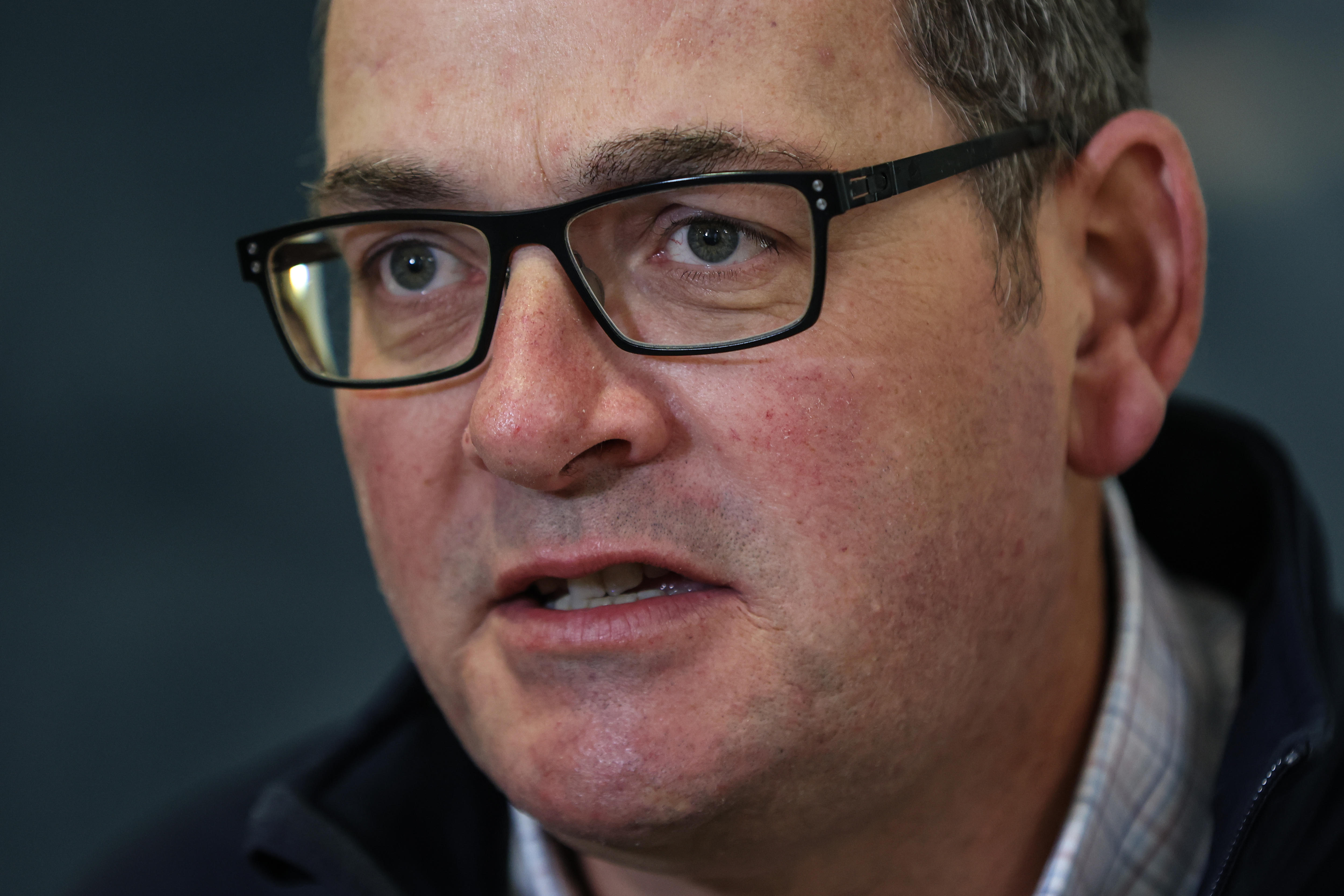 Premier Daniel Andrews appears serious as he speaks to journalists.