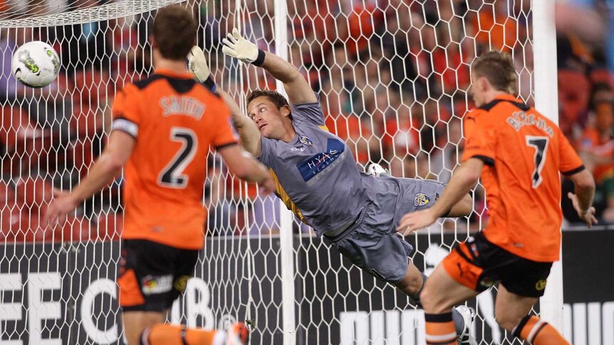 Paartalu scores... Gold Coast United goalkeeper Glen Moss dives in vain as the Brisbane Roar open their account.