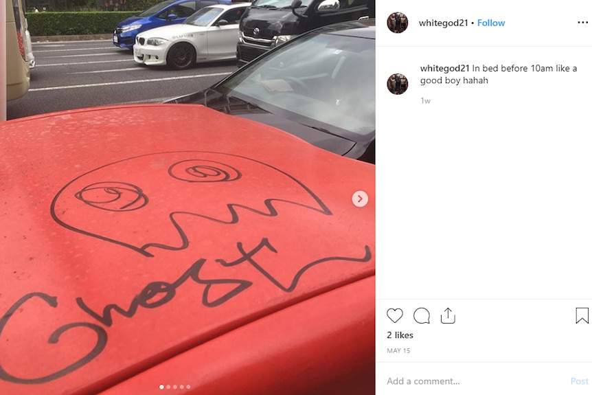 A red car with "Ghost" scrawled across the hood