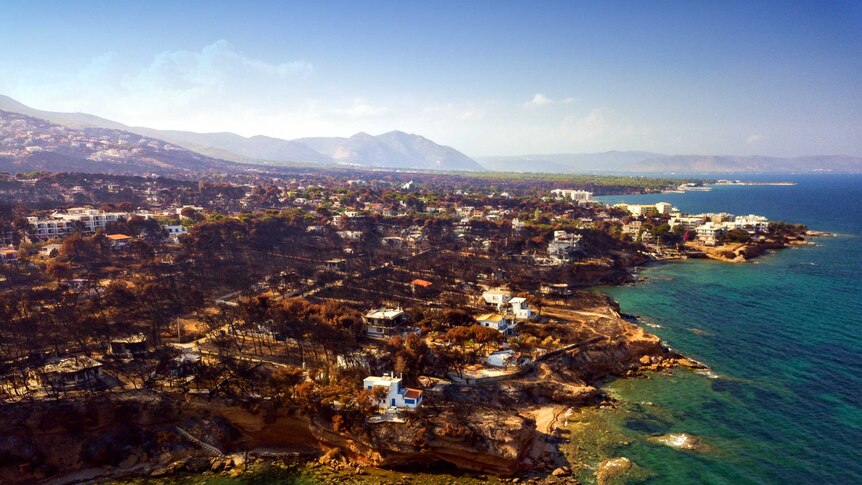 An aerial view of the burnt out town of mati on the coastline of greece.