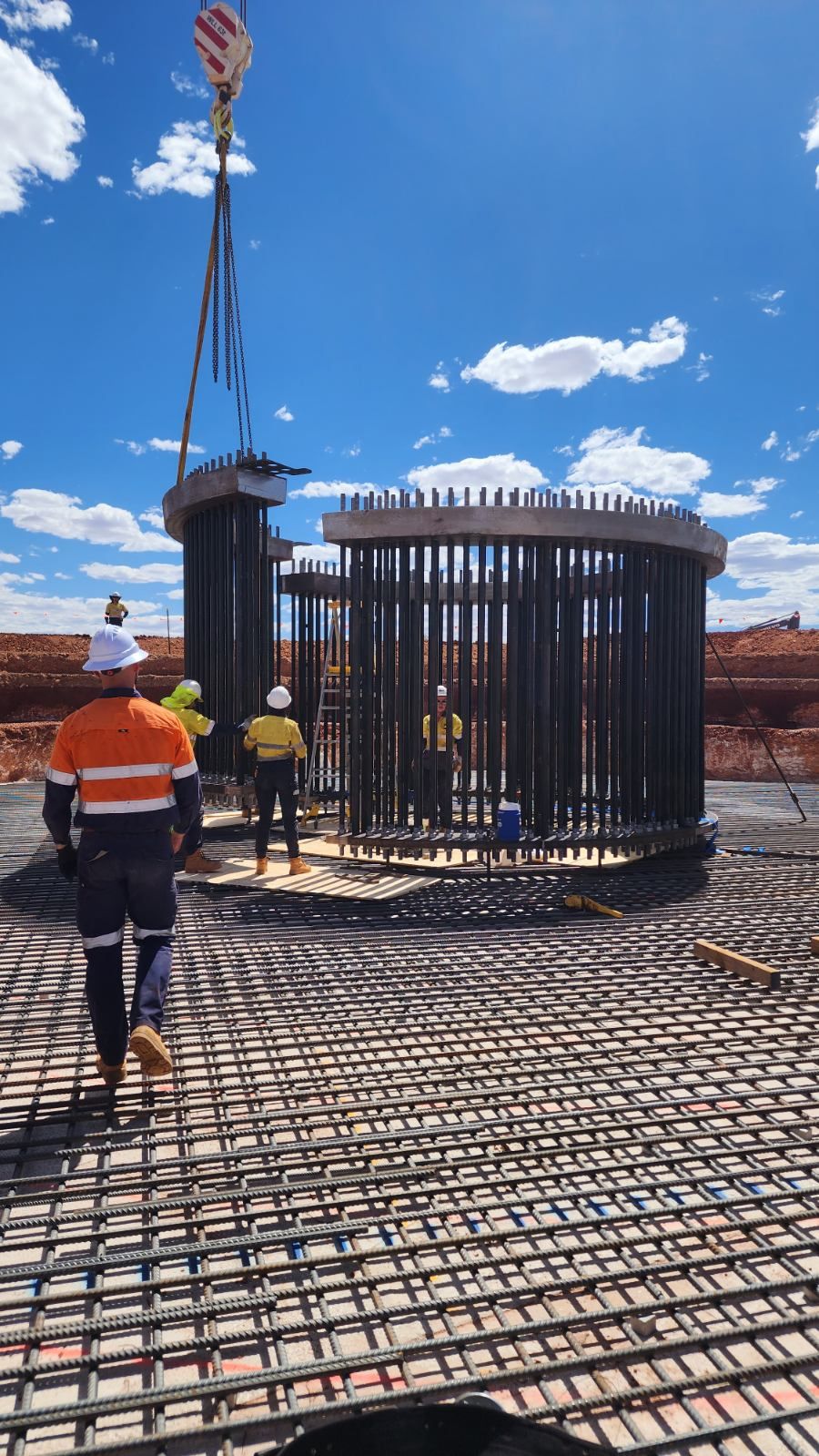 Construction workers building footings for wind turbines at remote mine site.  