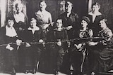 A formal black and white image of nine women.