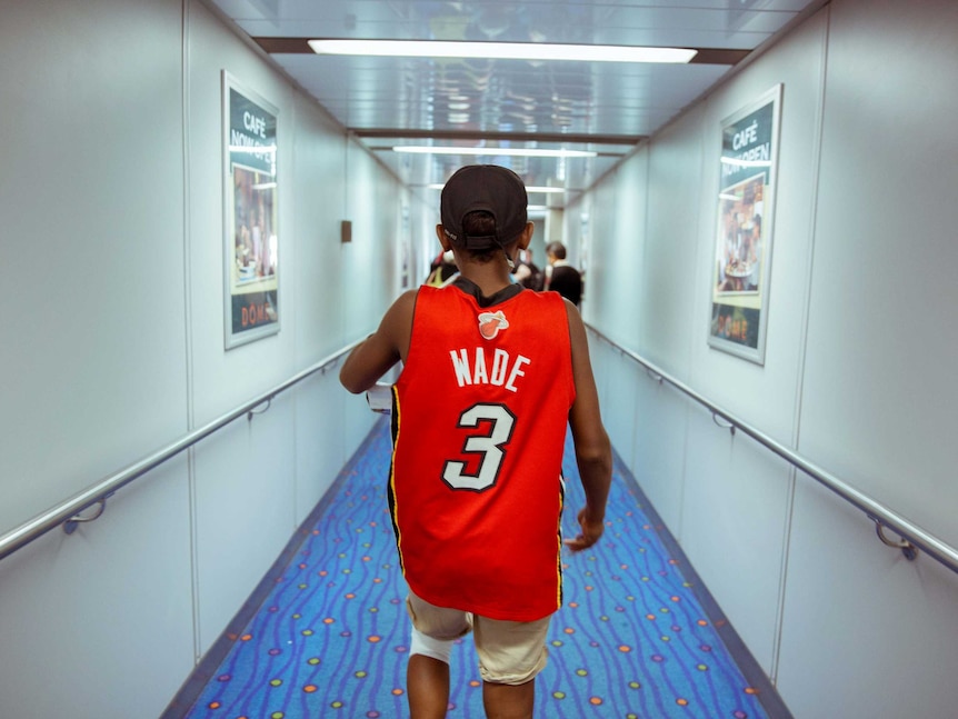 Junior boards a plane to Melbourne.