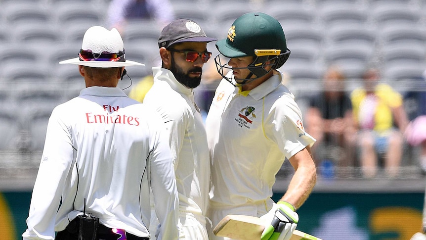 India captain Virat Kohli and Australia captain and batsman Tim Paine touch torsos during a cricket Test.