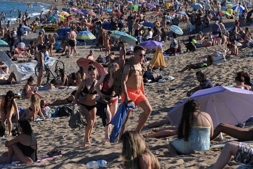 People pack a Spanish beach in Barcelona.