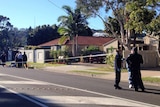 Forensic police outside crime scene at house at Coolum Beach