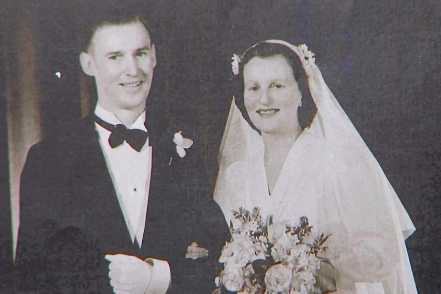 A black and white photo of a wedding couple 