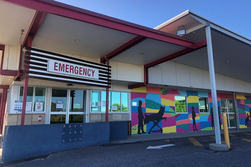 A sign that says emergency on a single storey building