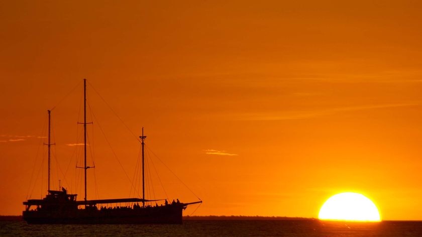 A ship sits off Mindil Beach, Darwin, at sunset