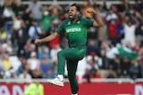 Pakistan cricketer Wahab Riaz jumps to punch the air after taking a wicket.