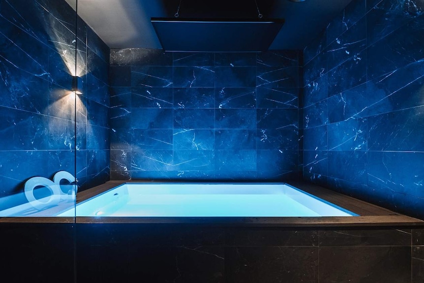 A blue-lit float tank room at the City Cave Float Centre at Paddington in inner-city Brisbane