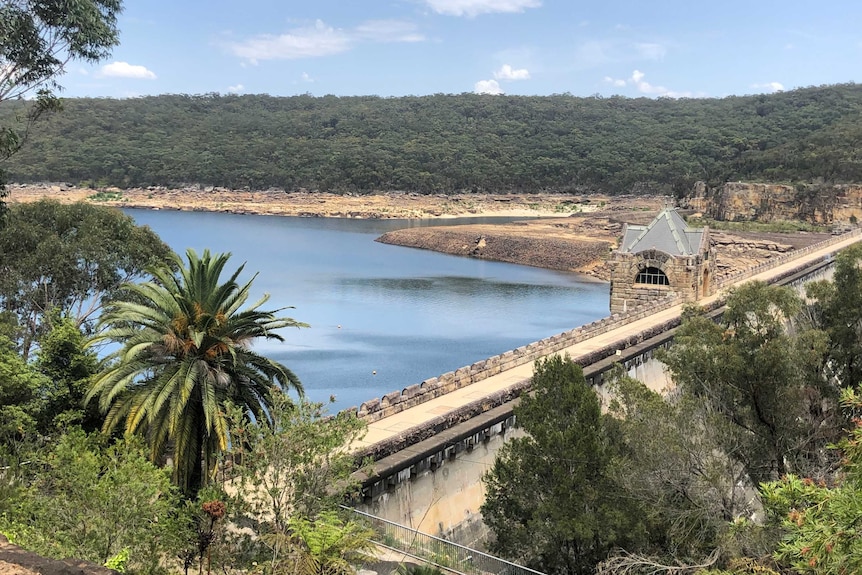 An angled shot of the Cataract Dam from over the top of the dam wall.