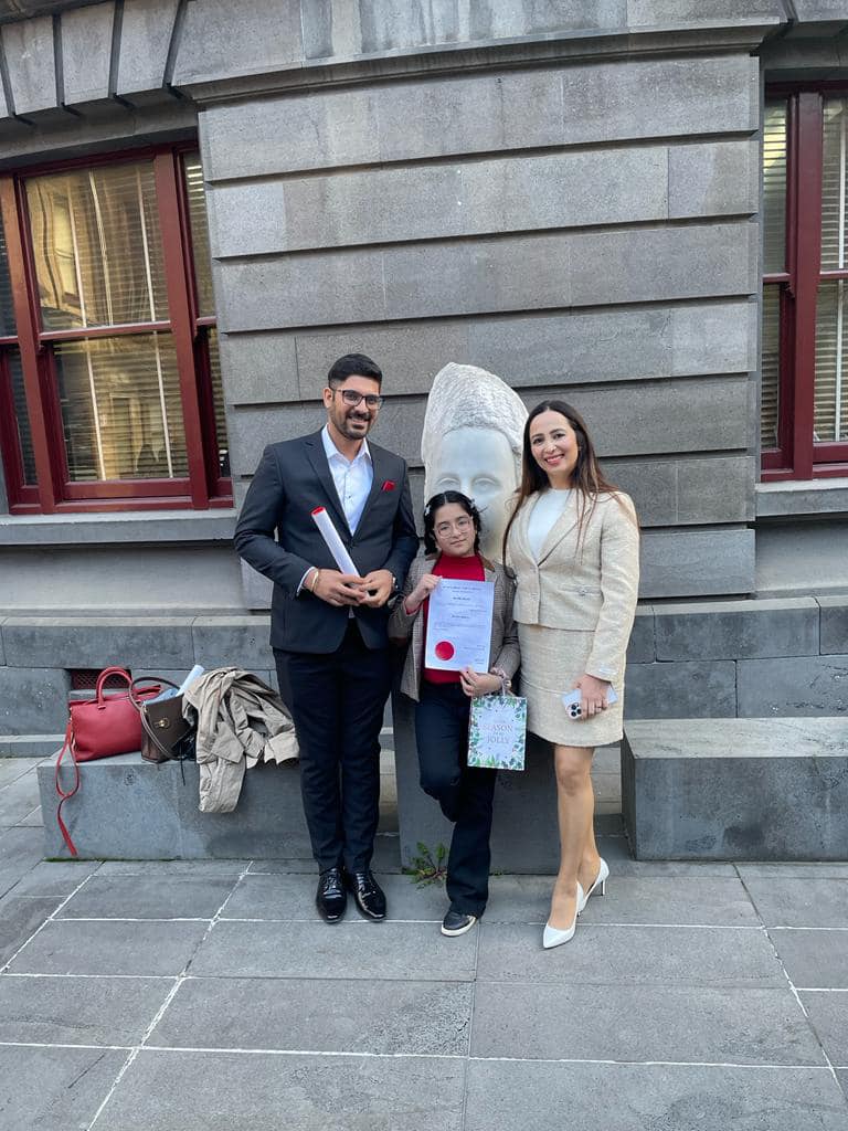 A family standing with a certificate