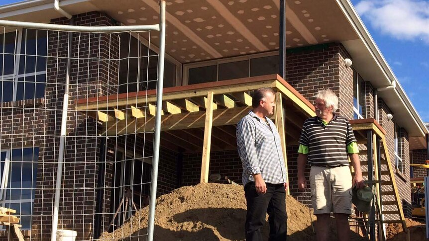 Developer Darren Goodyer with a builder in Launceston.