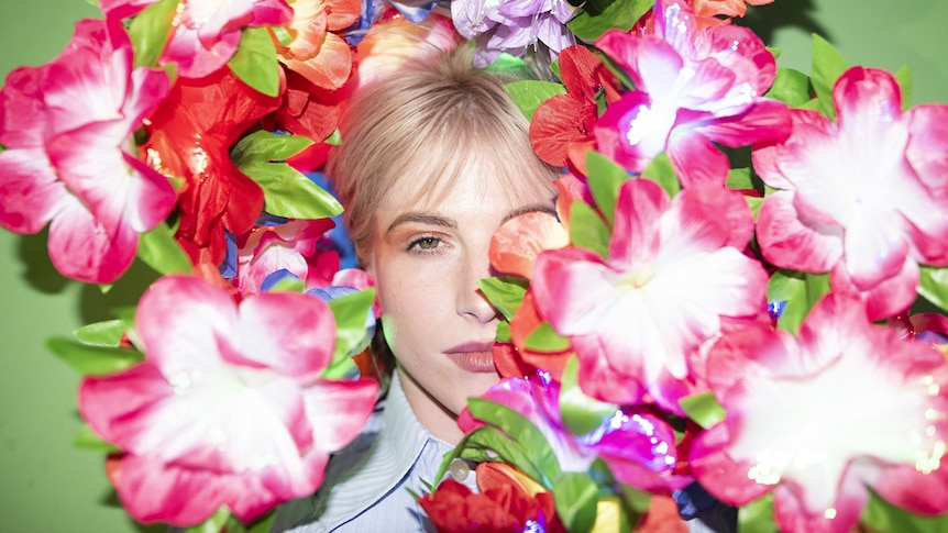 A 2020 press shot of Hayley Williams covered in flowers