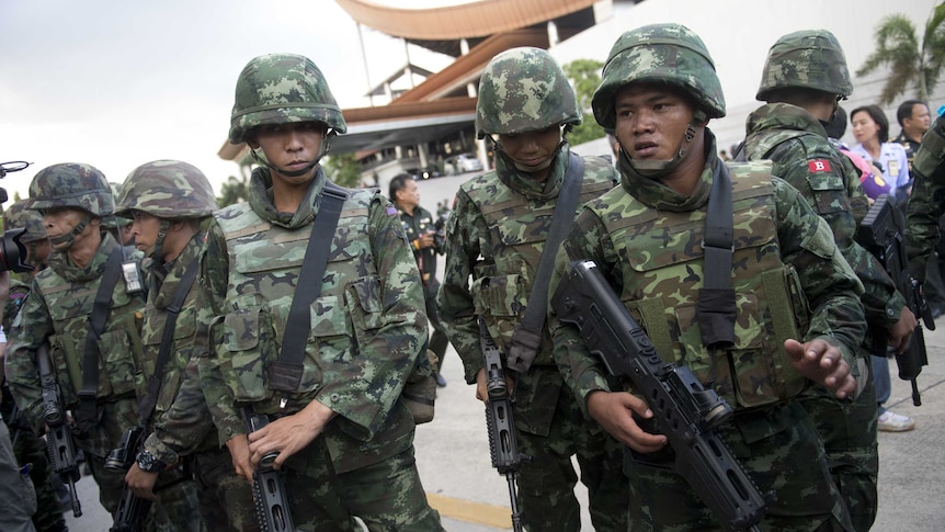 Thai soldiers stand guard after the army chief announced a coup