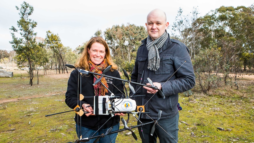 ANU researchers Debbie Saunders and Adrian Manning with the radio tracking drone they developed