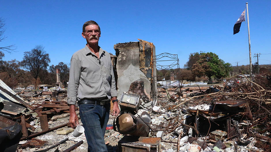 Les Liddington stands among the wreckage of his Yarloop home.
