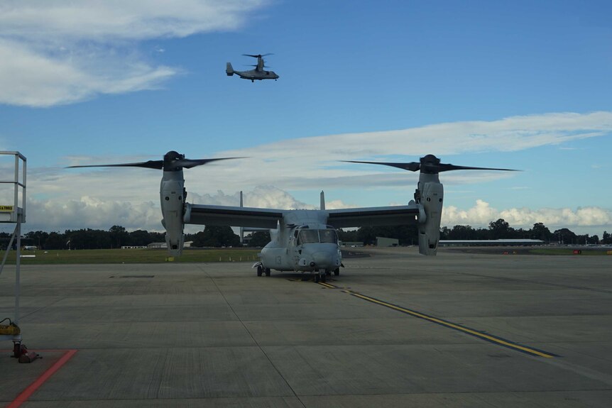 helicopters and military aircraft are seen flying at a base near Sydney.