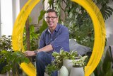 A man sits among his indoor plant collection in Melbourne, teaching how to treat common plant fungus and pest problems.