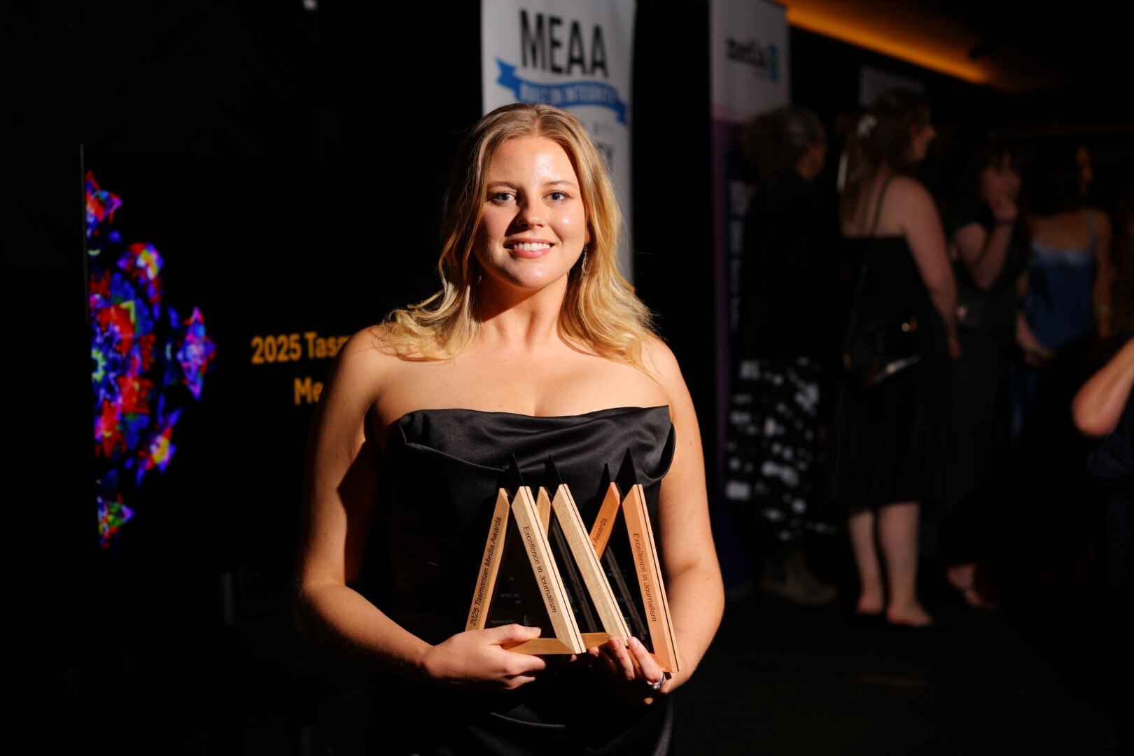 April McLennan holding herTasmanian 2025 Journalist of the Year trophy at the awards ceremony